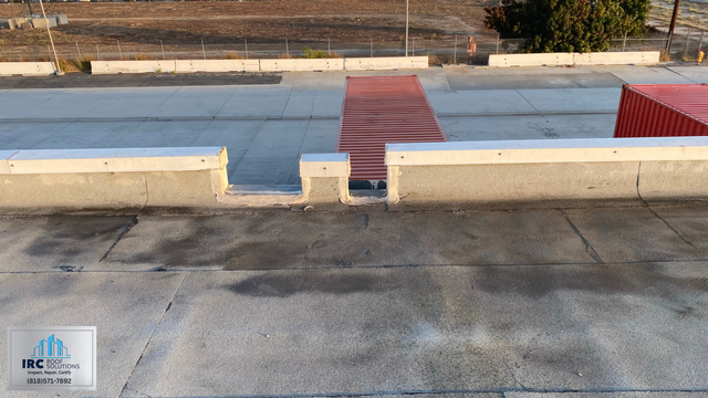 White coated commercial roof surface after restoration work.
