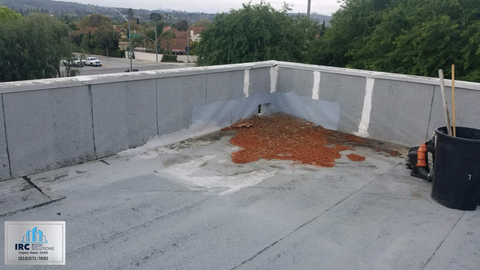 Large commercial roof field with mechanical units and open membrane sections.
