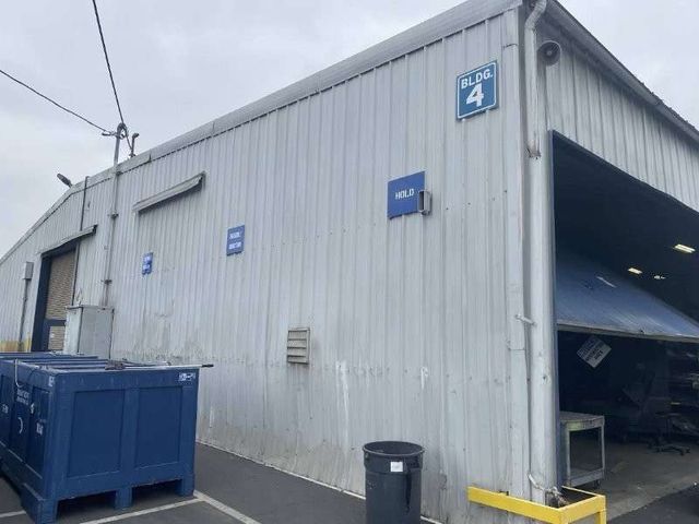 Commercial metal wall and roof panel replacement with new light panels installed.